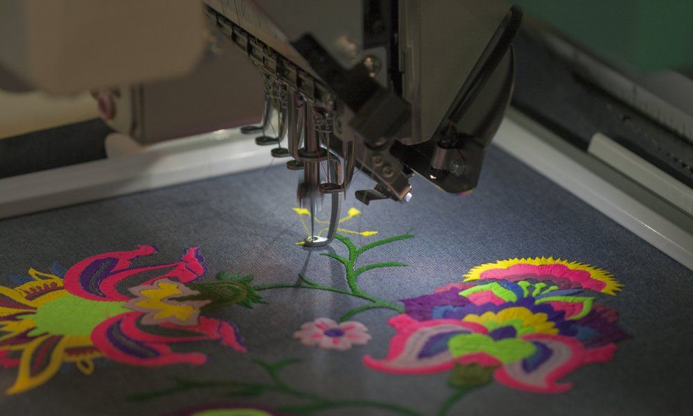 an embroidery machine stitching flowers