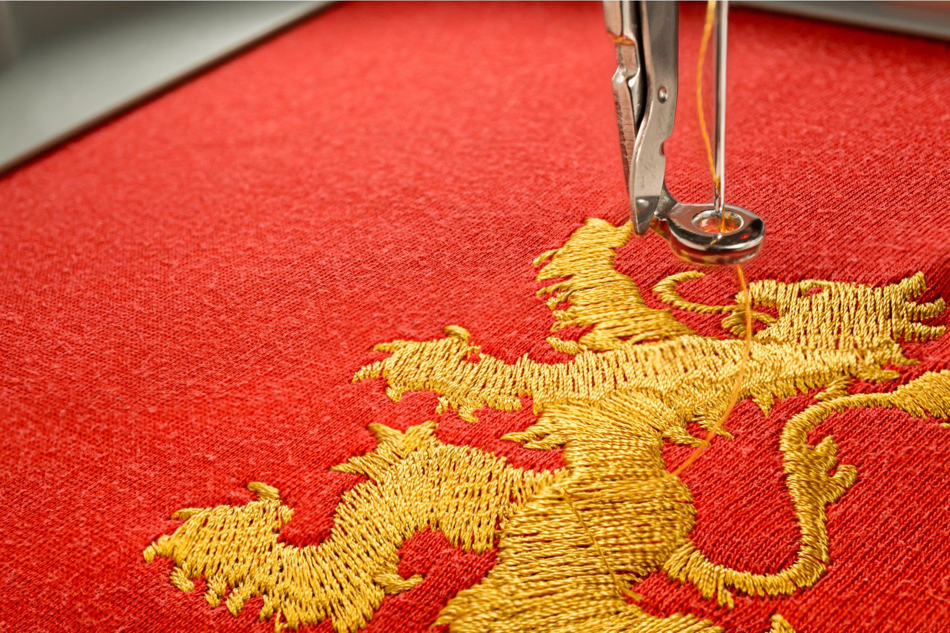 an embroidery machine stitching a dragon