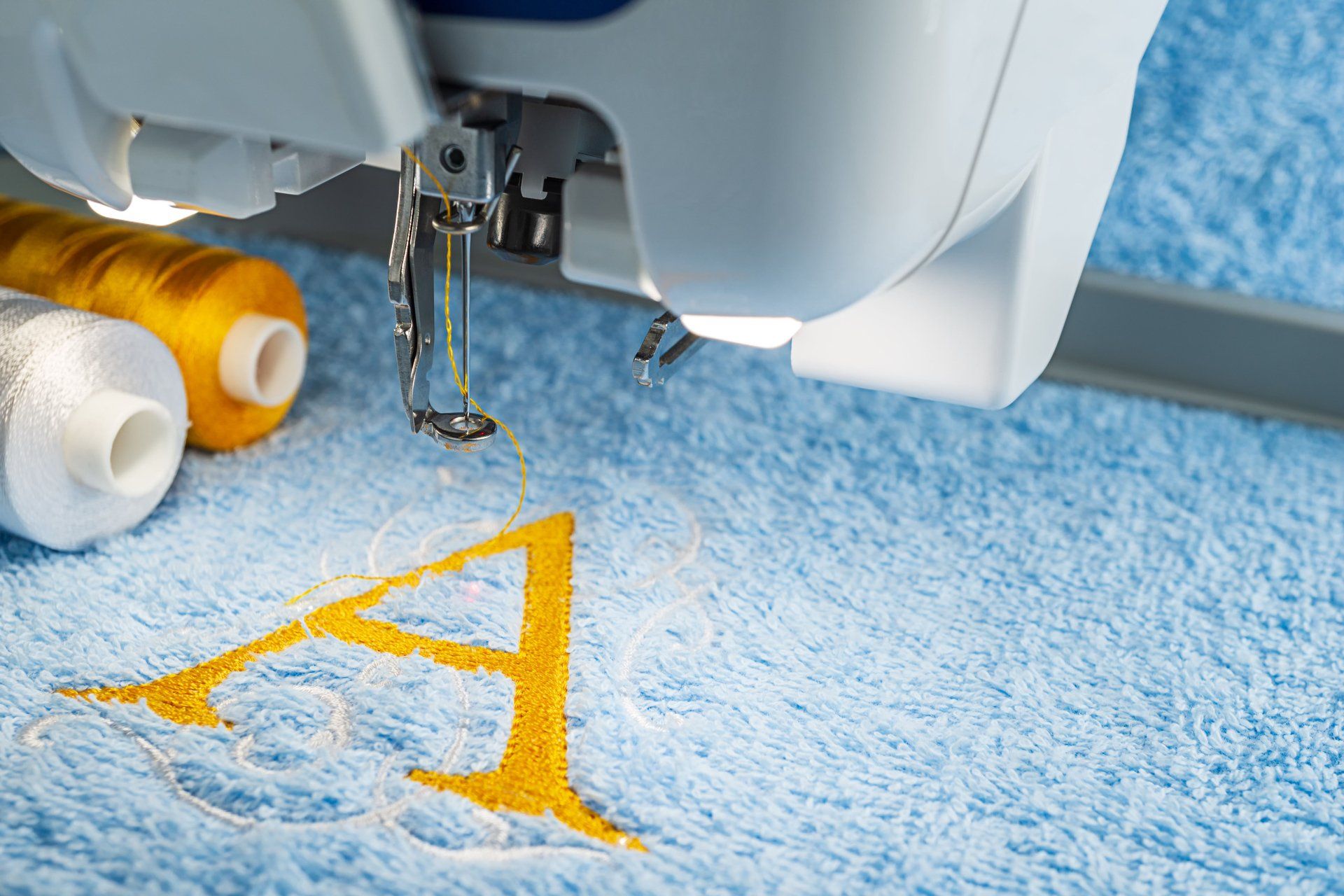 an embroidery machine stitching a monogram
