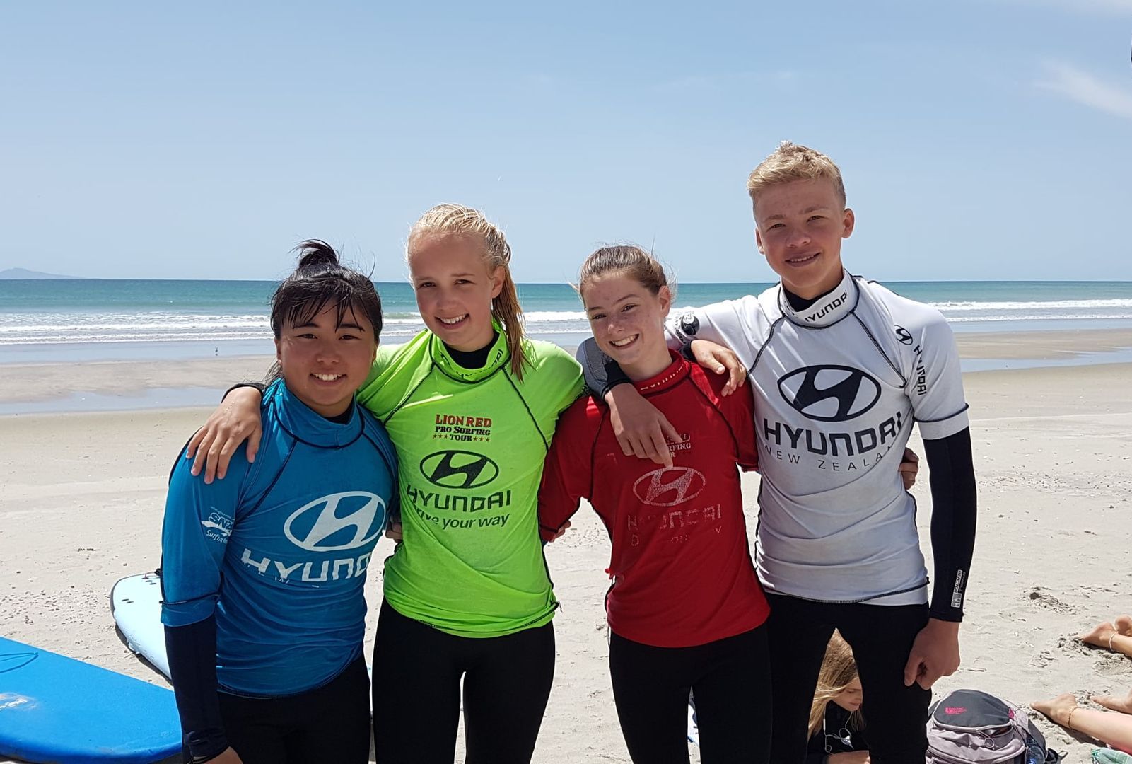 Auslandsjahr Switch You SchülerInnen stehen am Strand mit Surfshirts