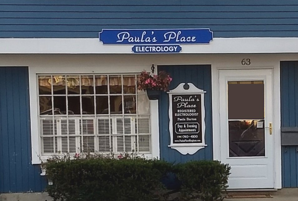 Front of Paula's Place with New England style blue siding and white trim building