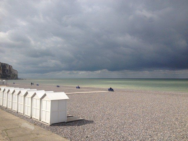 Beach huts at Eu le Tréport, stormy sky