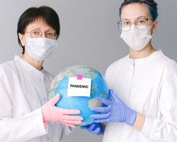 people-with-face-masks-and-latex-gloves-holding-a-globe-4167561-15b89b83