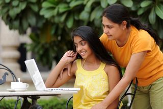 Photo of parent and teen working on a computer