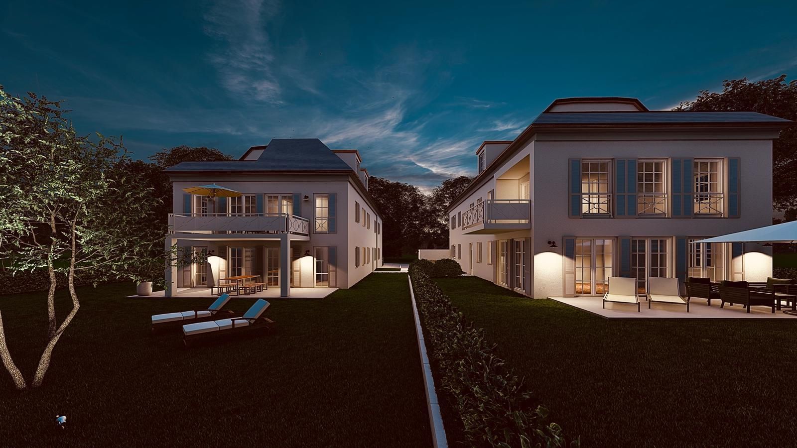 Zweistöckige Häuser bei Nacht, mit beleuchteten Innenräumen und Sitzgelegenheiten im Freien auf einer Rasenfläche.