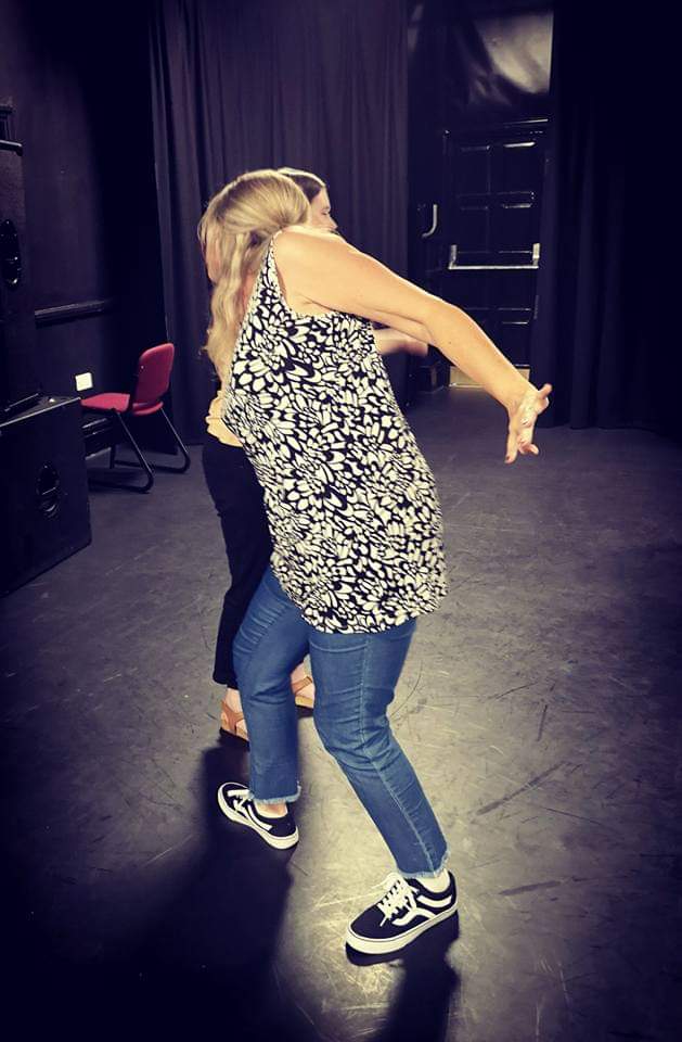 Tracey mid spin facing away form camera arms outstretched