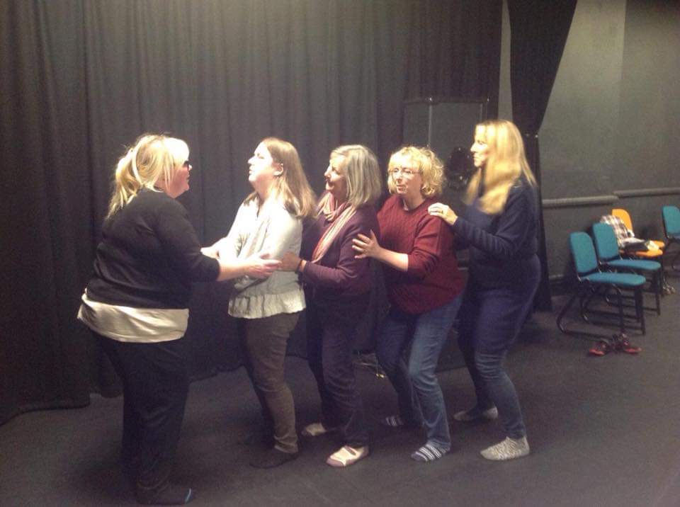 Group in line being guided by facilitator Elizabeth