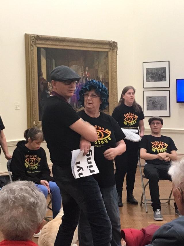At Bury Art Museum event. Mags and paul in centre of image, Paul is wearing a flat cap. everyone in Engage2stage tshirts