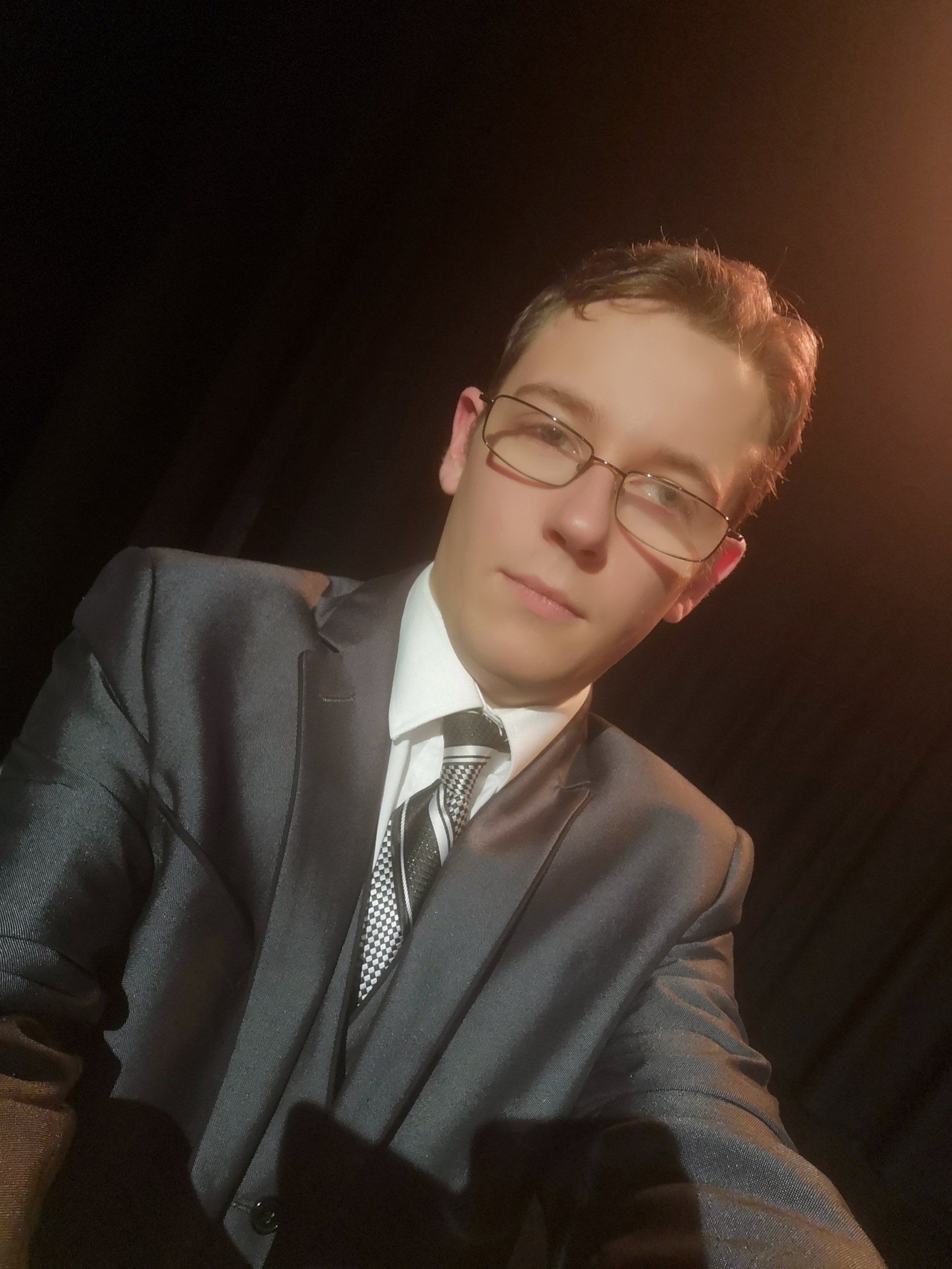 Anthony wearing suit looking business like