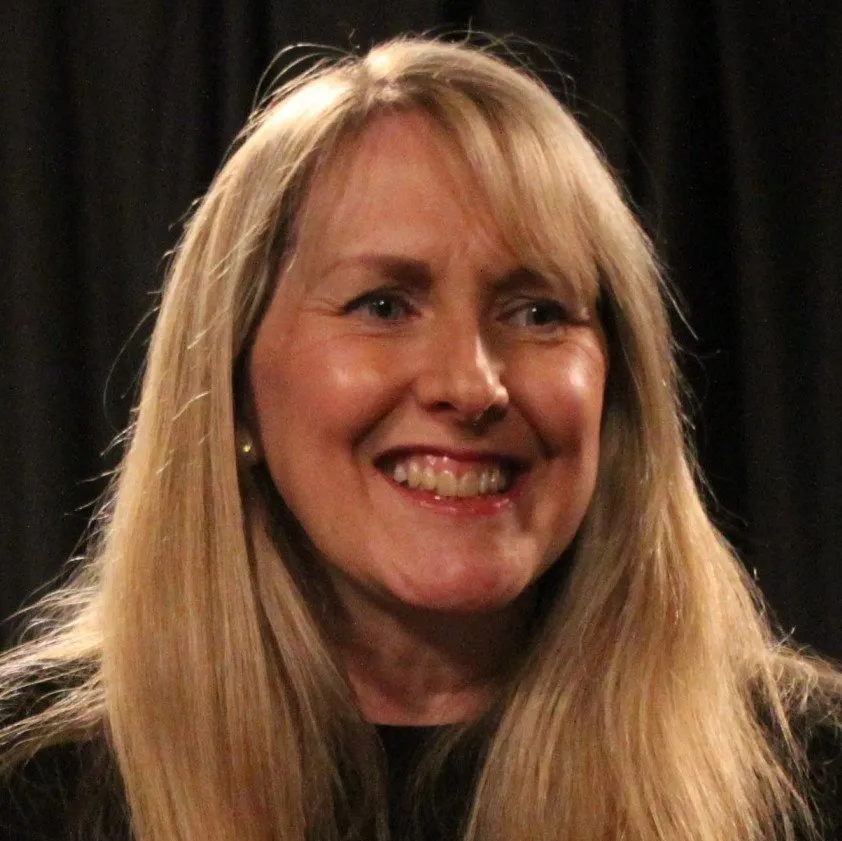 headshot of Tracey Marno. Long blond hair, smiling
