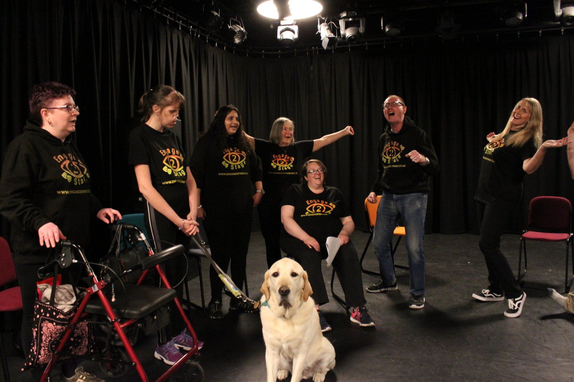 Group participating in workshop while a guide dog sits in the foreground of image