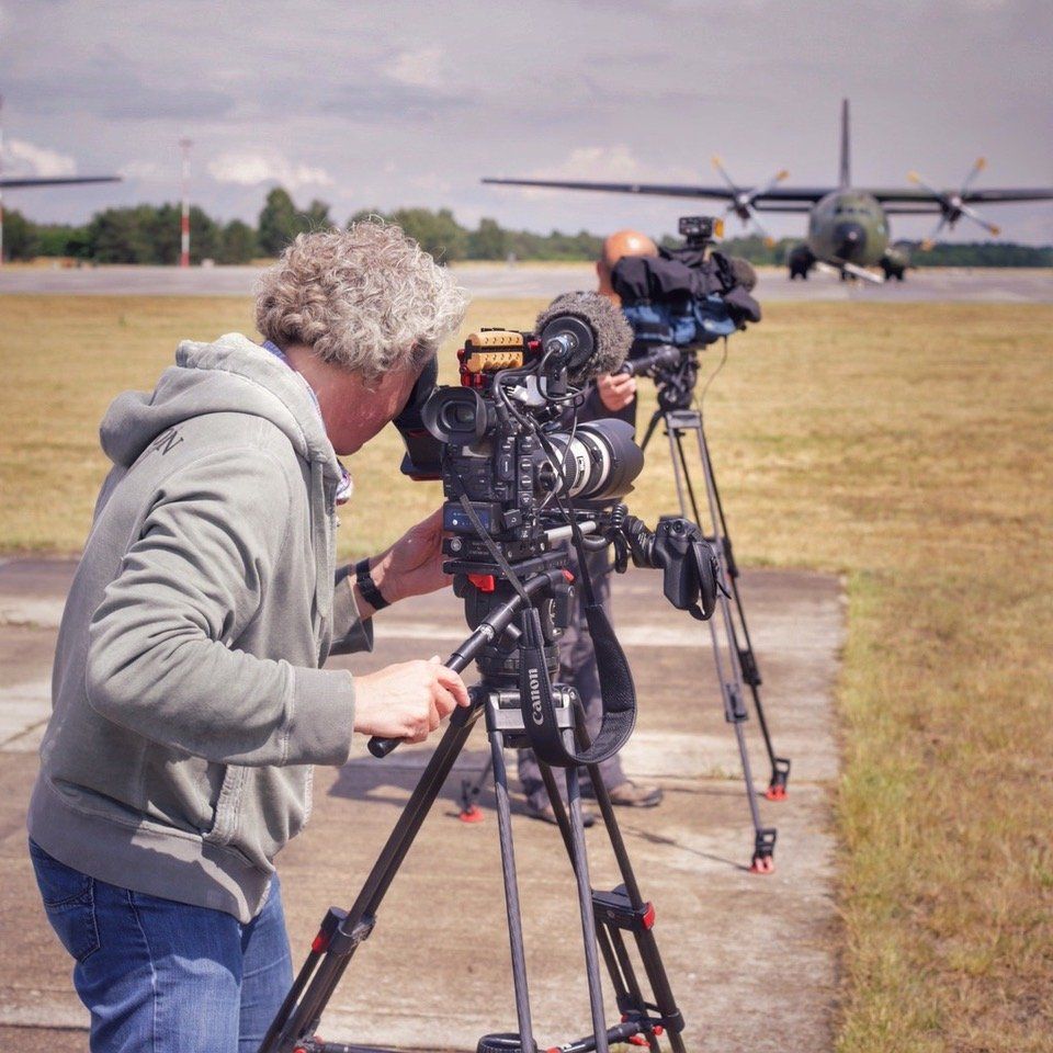 pictures in motion Kameramann dreht Militärflugzeug auf dem Flughafen