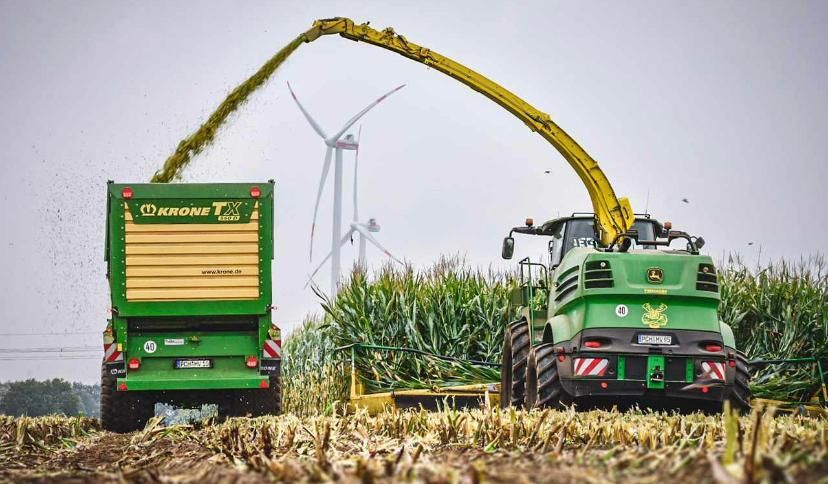 John Deere Häcksler mit Krone TX Abfahrwagen bei der Maisernte. Finde jetzt deinen Platz bei Agri-Crew