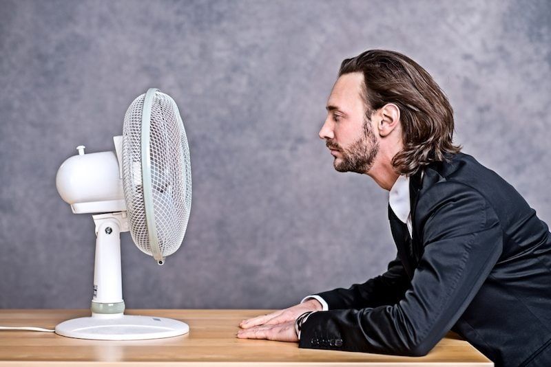 Man in front of a fan 