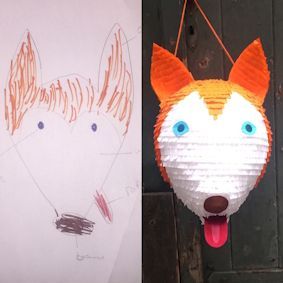 Zeichnung eines Fuchskopfes neben einer Piñata, die der Zeichnung nachempfunden ist, mit weißem und orangefarbenem Fell und blauen Augen.