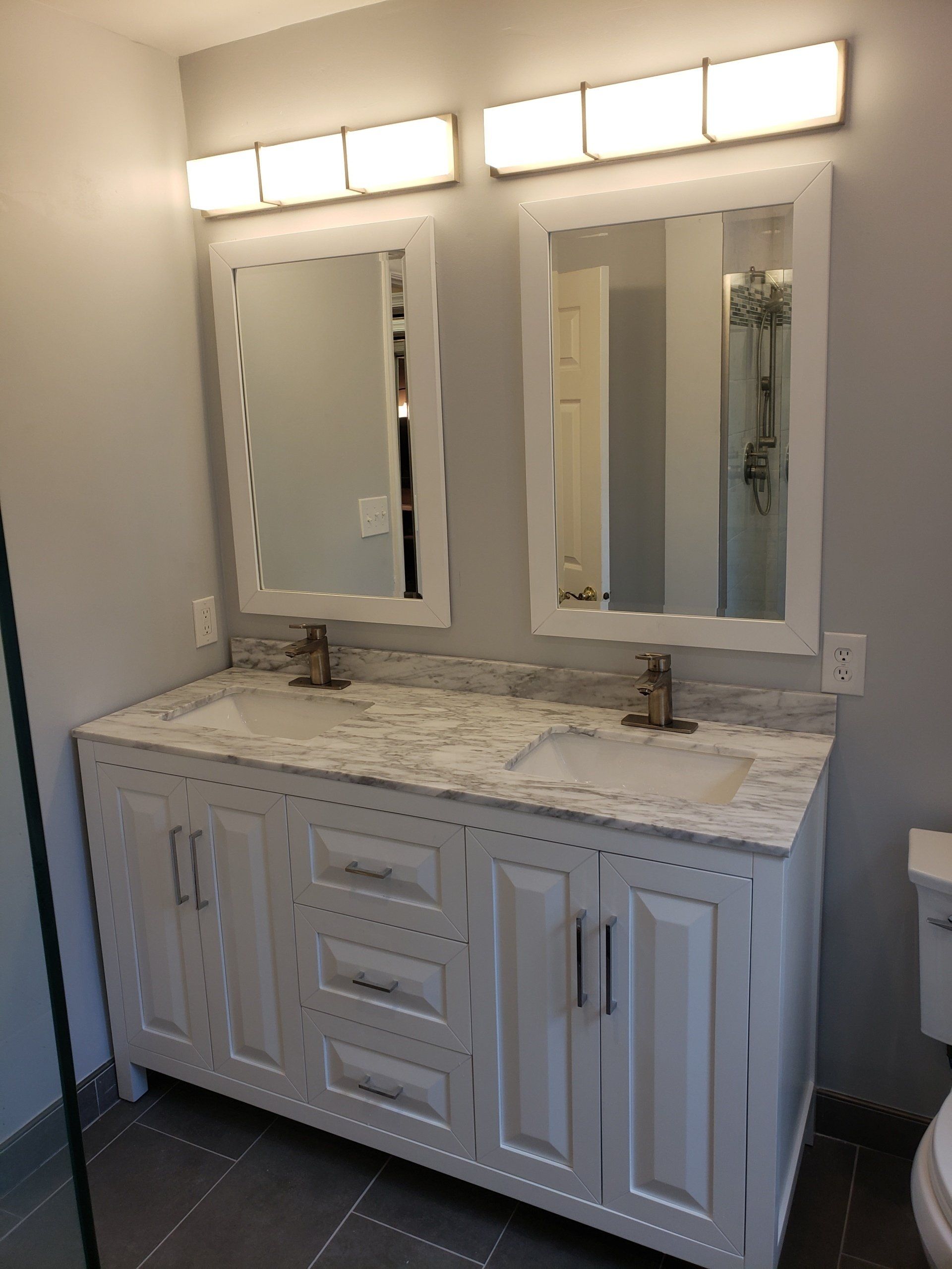 Double sink and double mirror vanity with modern design and marble top in elkins park bathroom remodel