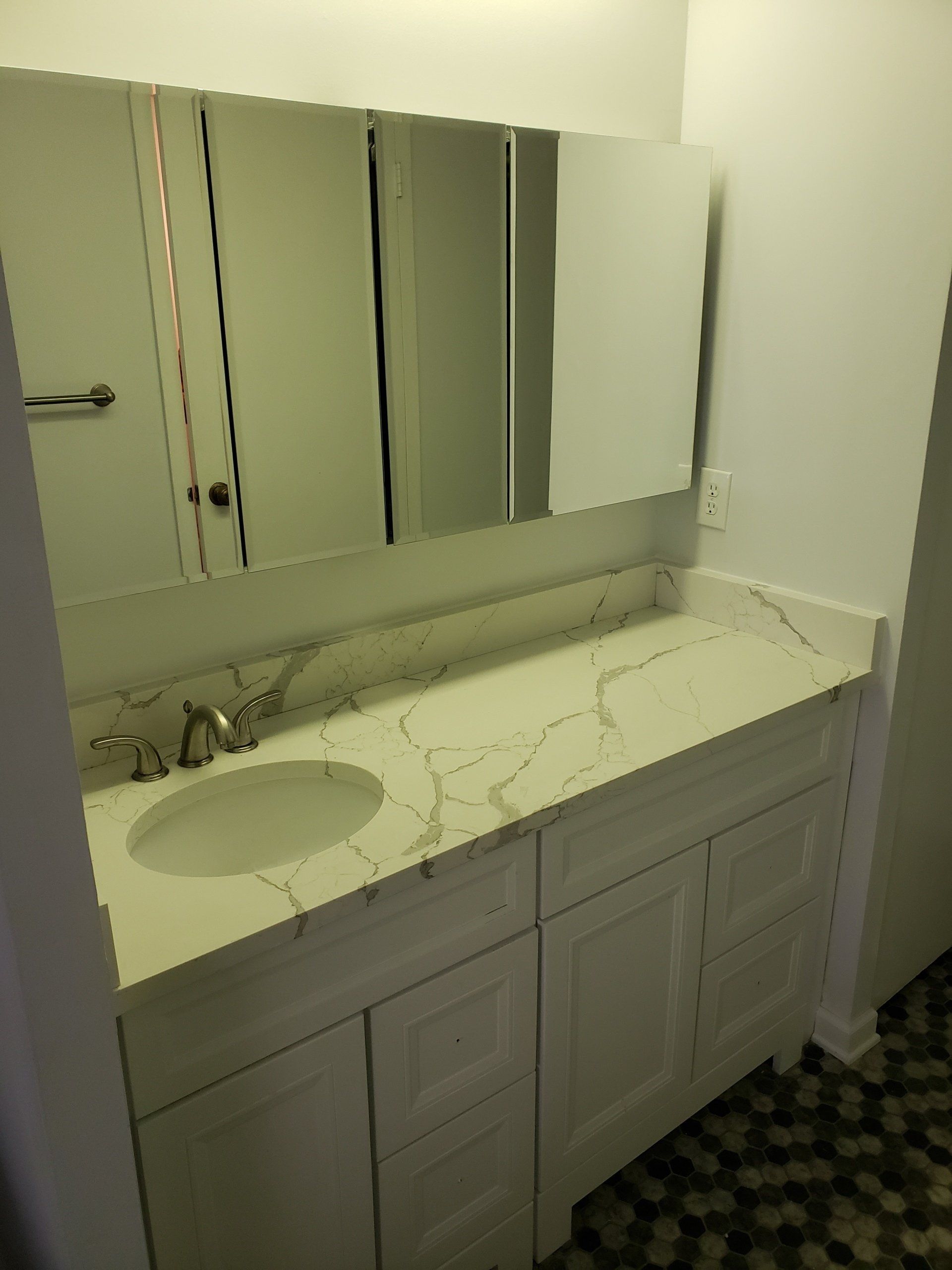 Jenkintown condo bathroom remodel close up of marble counter top, vanity and mirrors.