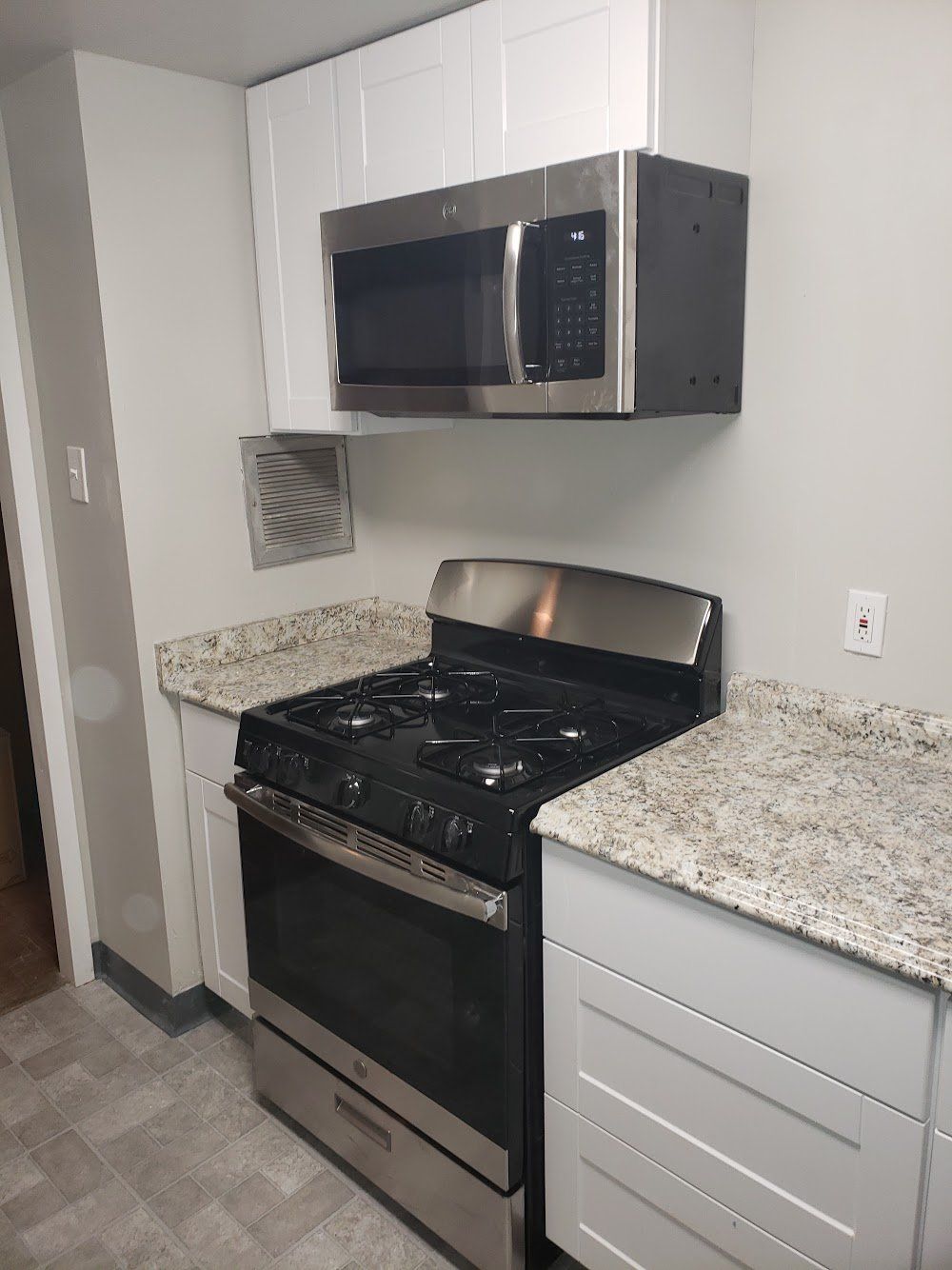 After photo of oven and laminate countertop and microwave in Jenkintown condominium remodel