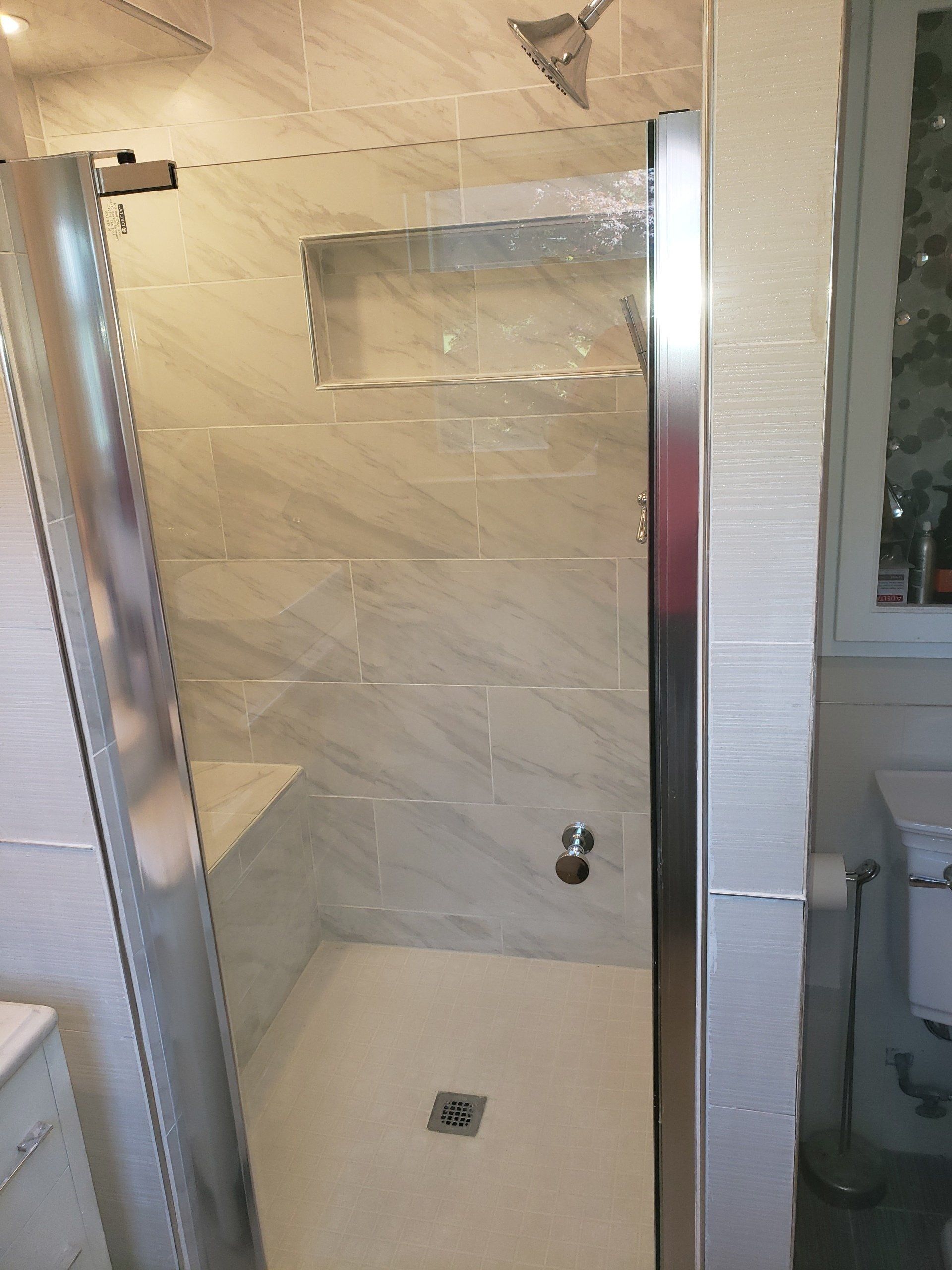 after photo of elkins park master bathroom shower expansion and remodel close up of mosaic floor tile and niche shelf