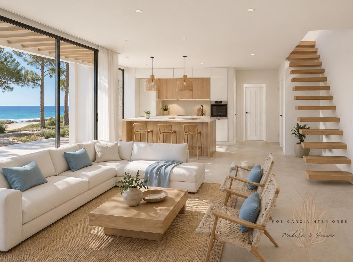 Salón mediterráneo moderno con vistas al mar, sofá blanco, cocina abierta, escalera de madera y decoración natural.