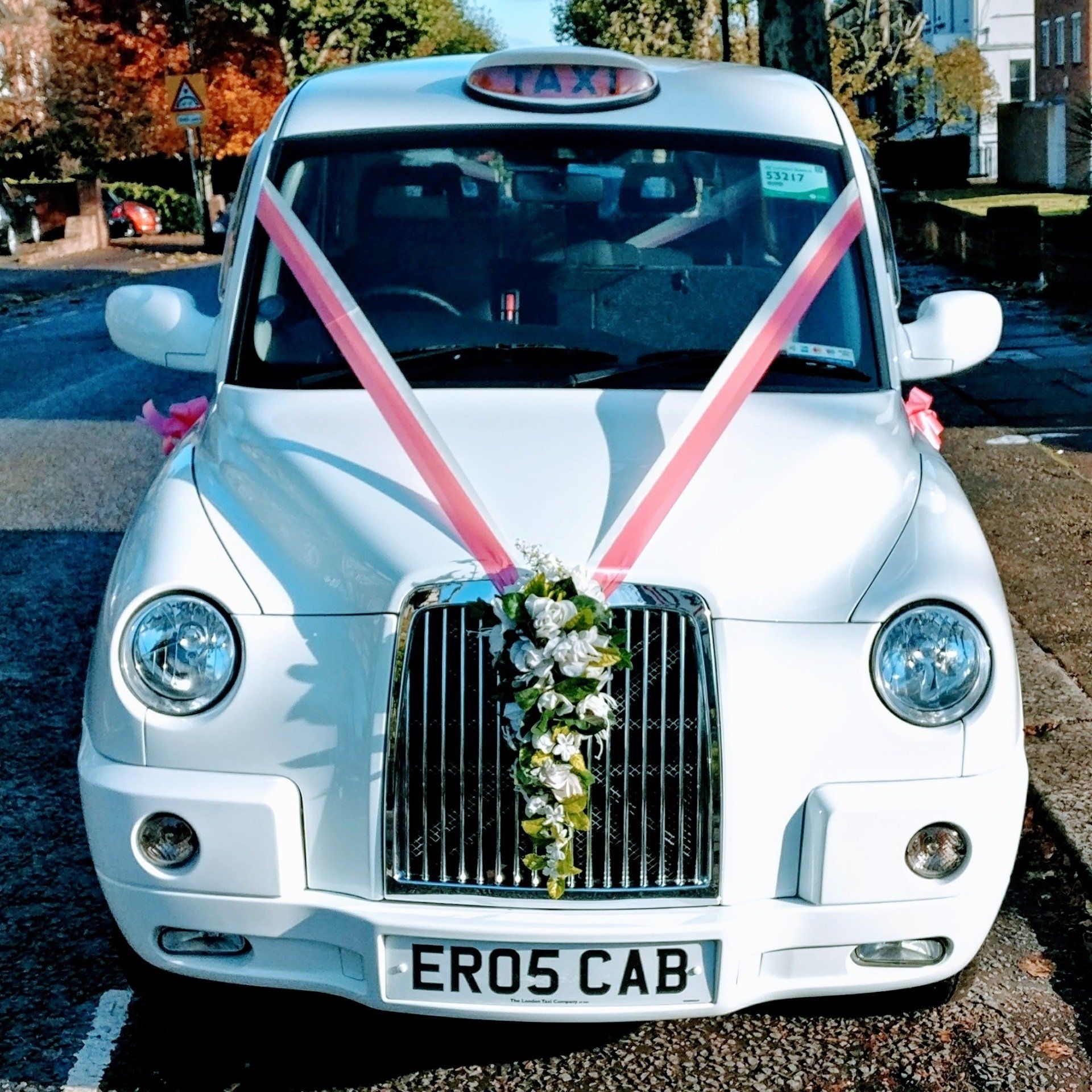 White Wedding Taxi with Coral & Cream Wedding Ribbons