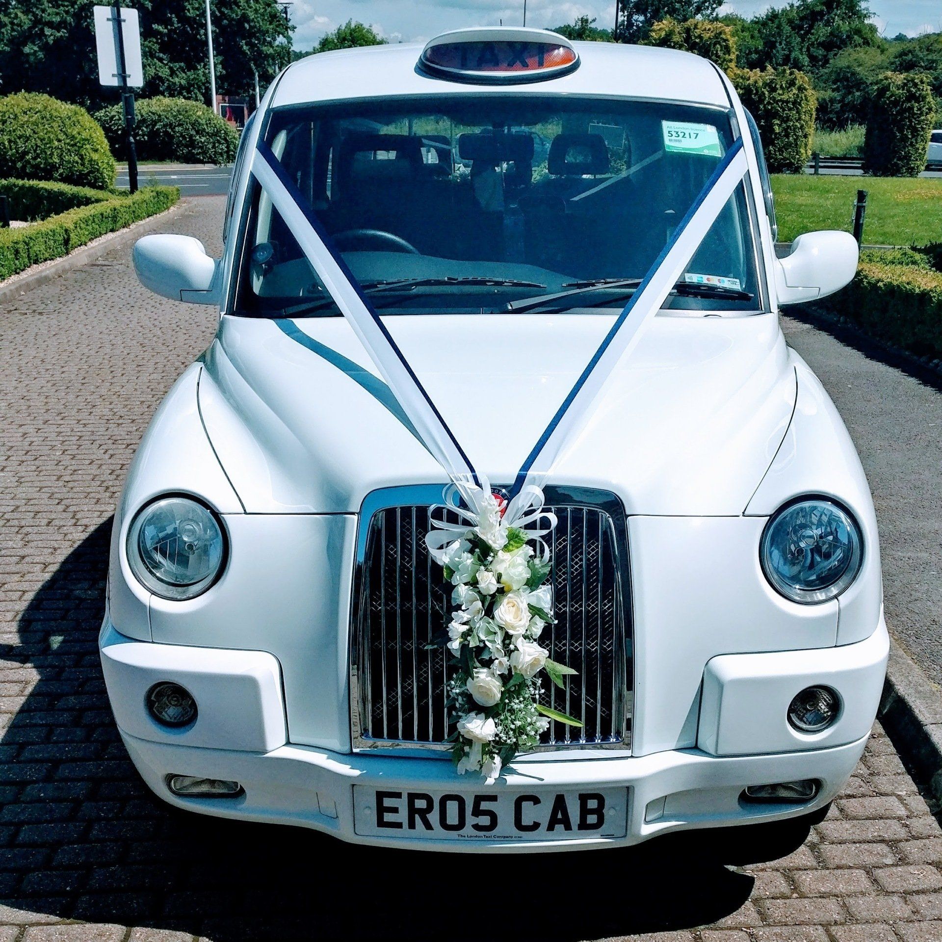 White Wedding Taxi with Navy Blue & White Wedding Ribbon