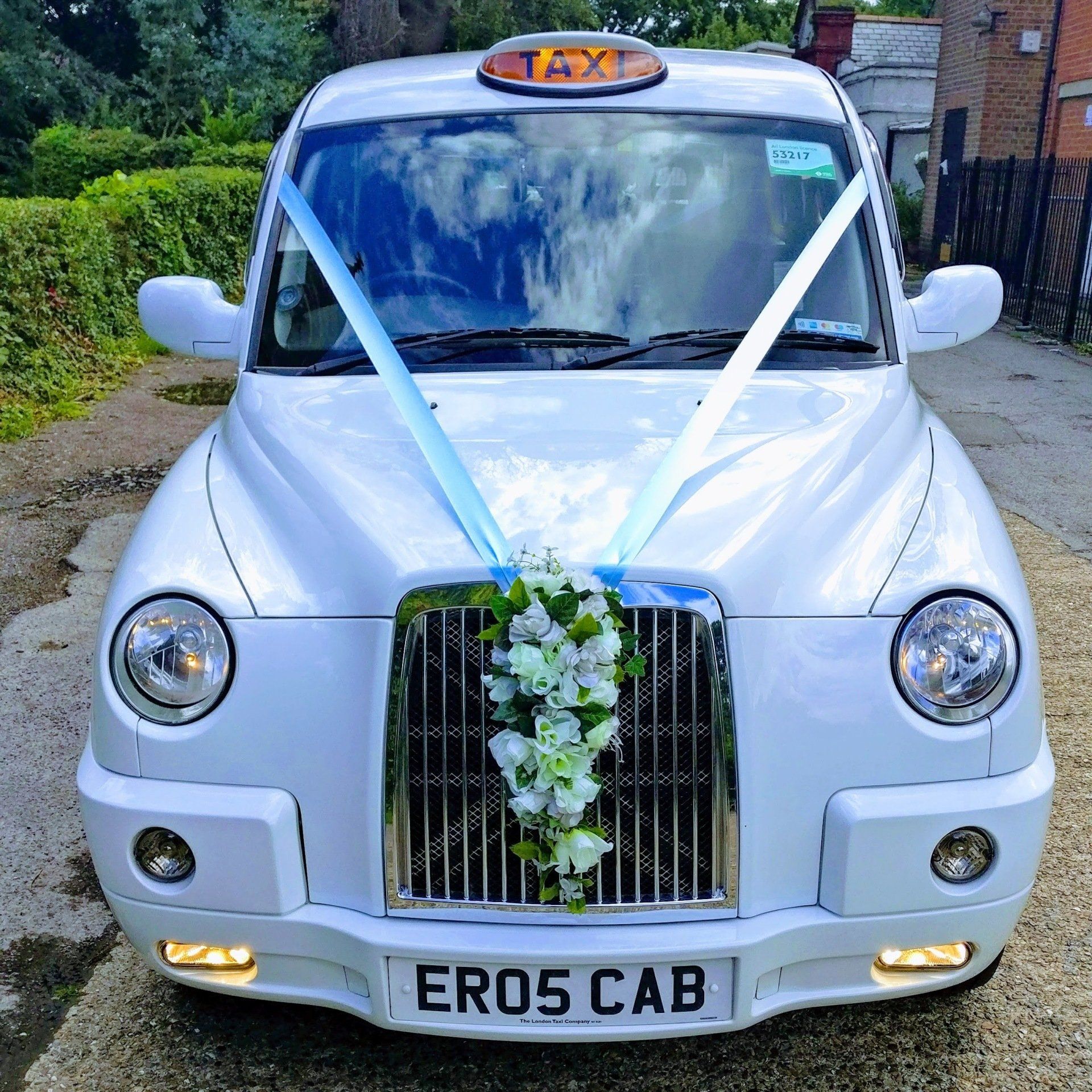 White Wedding Taxi with Pale Blue Wedding Ribbon