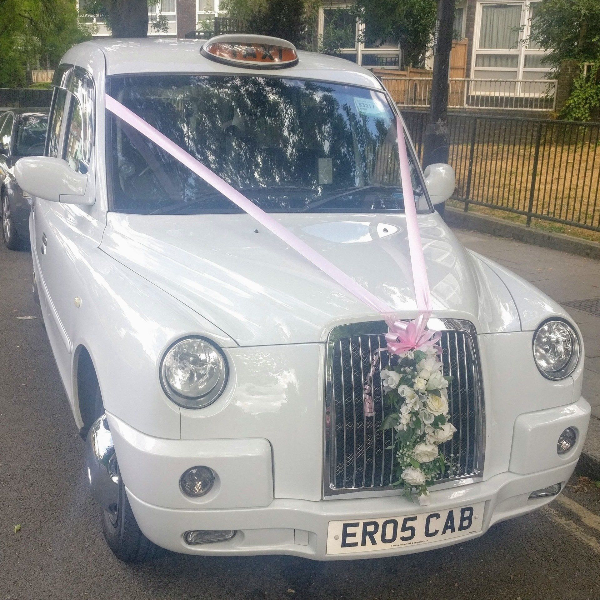 White Wedding Taxi with Baby Pink Wedding Ribbon