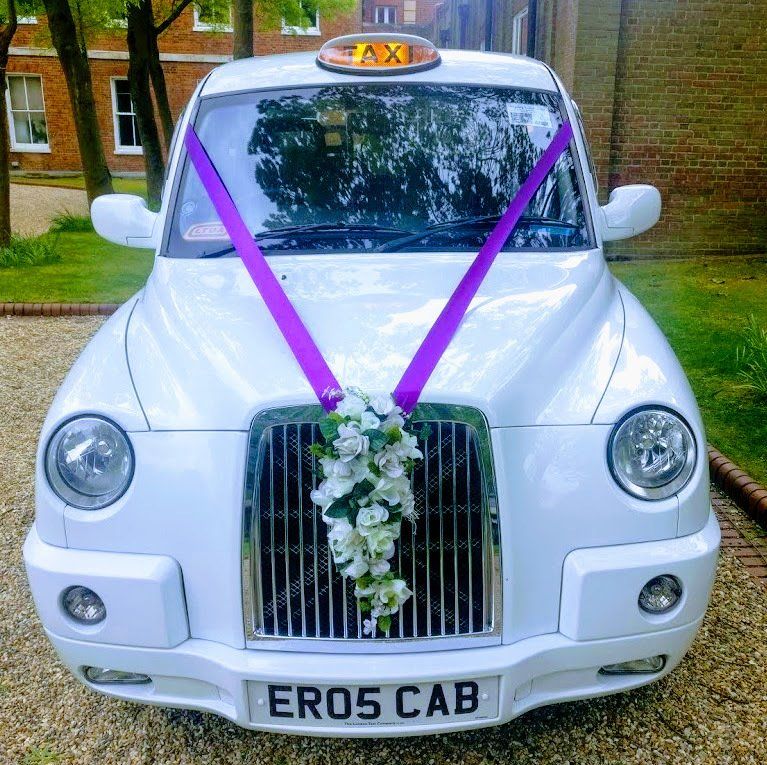 White Wedding Taxi with Purple Wedding Ribbon