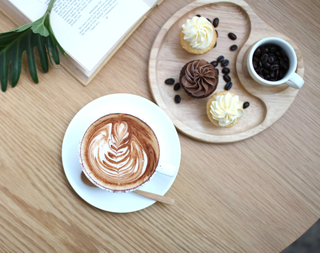 Coffee Cup and Cupcakes On Plate