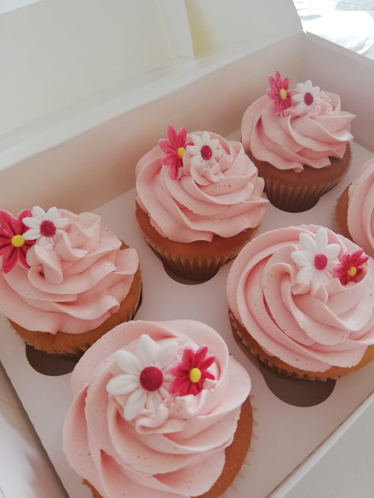 Vanilla cupcakes with pink buttercream swirls