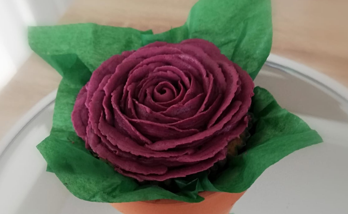 Magenta buttercream piped open rose