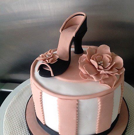 Round birthday cake with fondant shoe and flower