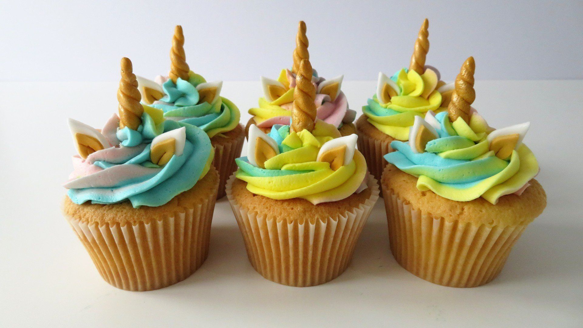 Unicorn multicoloured buttercream cupcakes with horn and ears