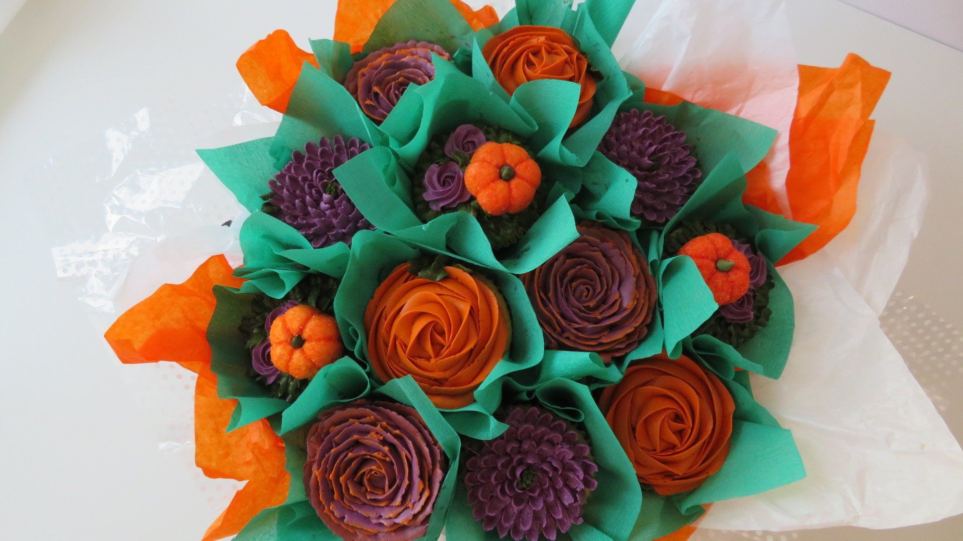 Halloween themed flower cupcakes with marshmellow pumpkins