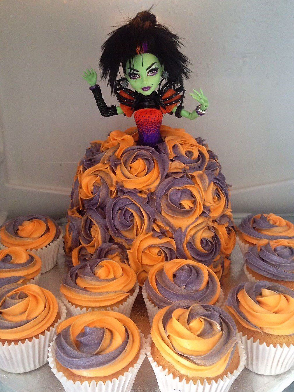 Doll cake with buttercream swirl dress and coordinating cupcakes