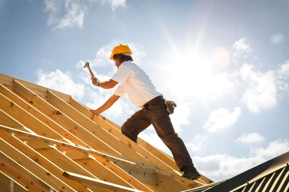 worker on a roof in the sun