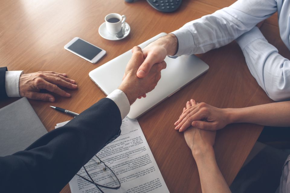 2 persons shaking hands