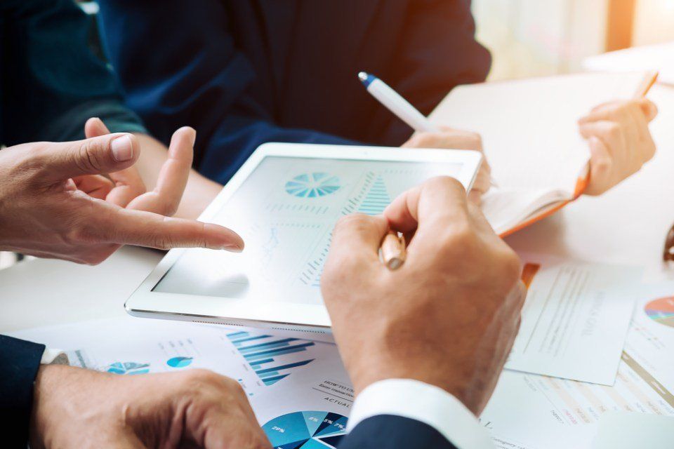 2 guys touching an ipad