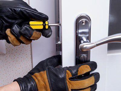 person setting up locks on a door