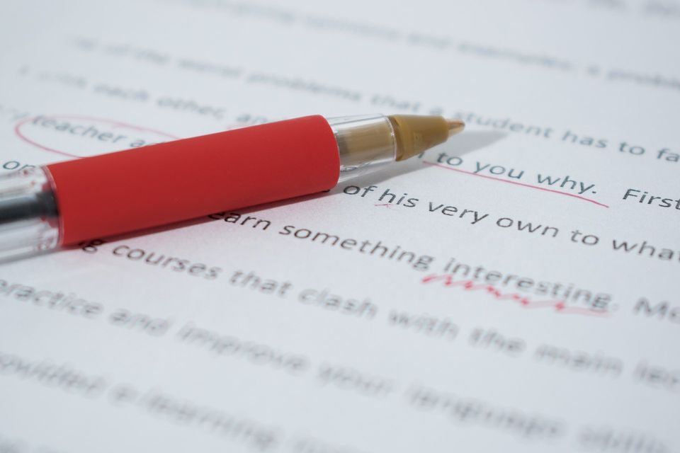 Proofreading red pen on paper