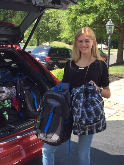 Young woman holding backpacks