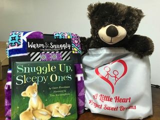 Bag with teddy bear, fleece blanket and a story book