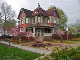 A large house with a fountain in the front yard