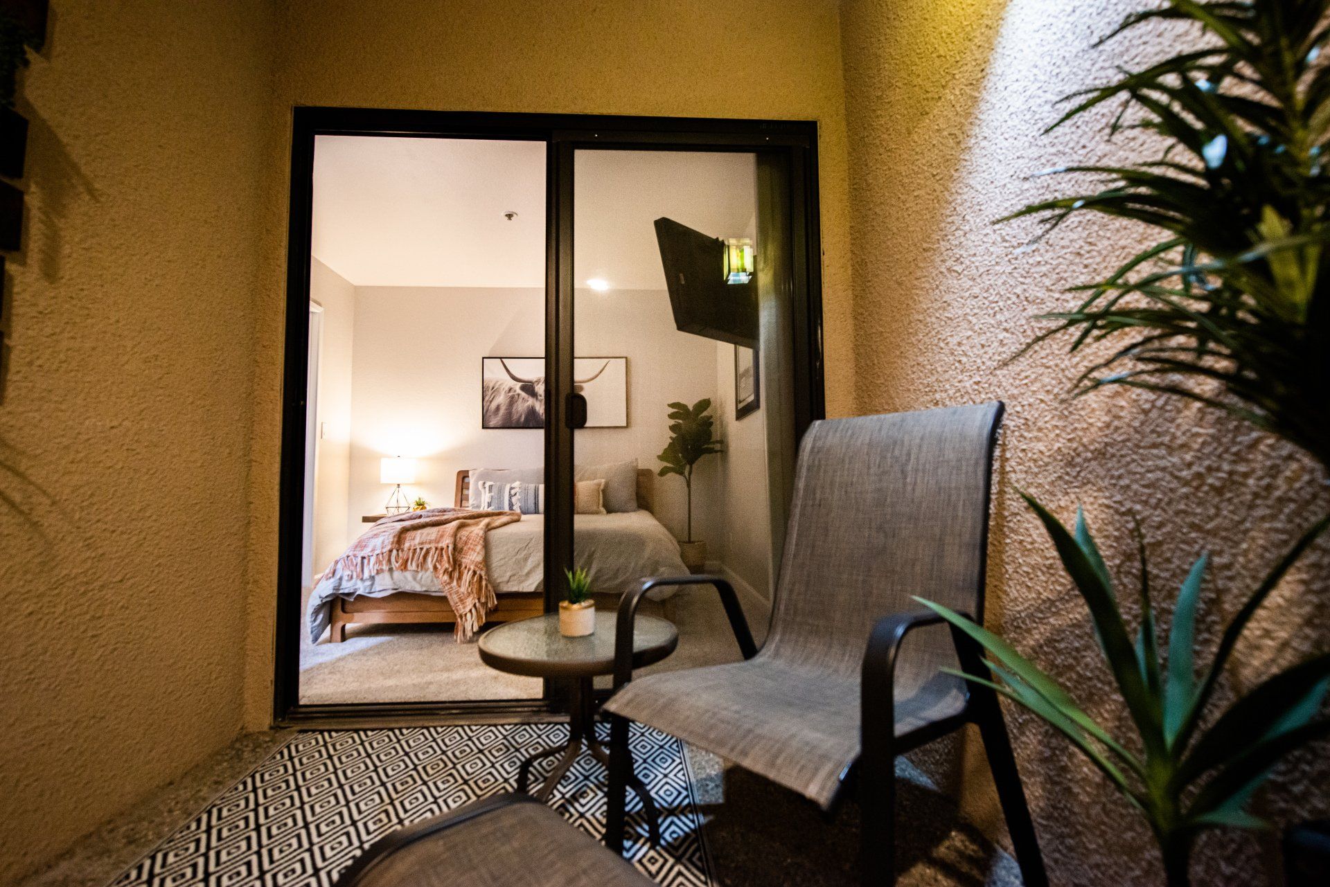 Harley's Desert Hacienda first floor queen guest bedroom with adjacent patio & sitting area