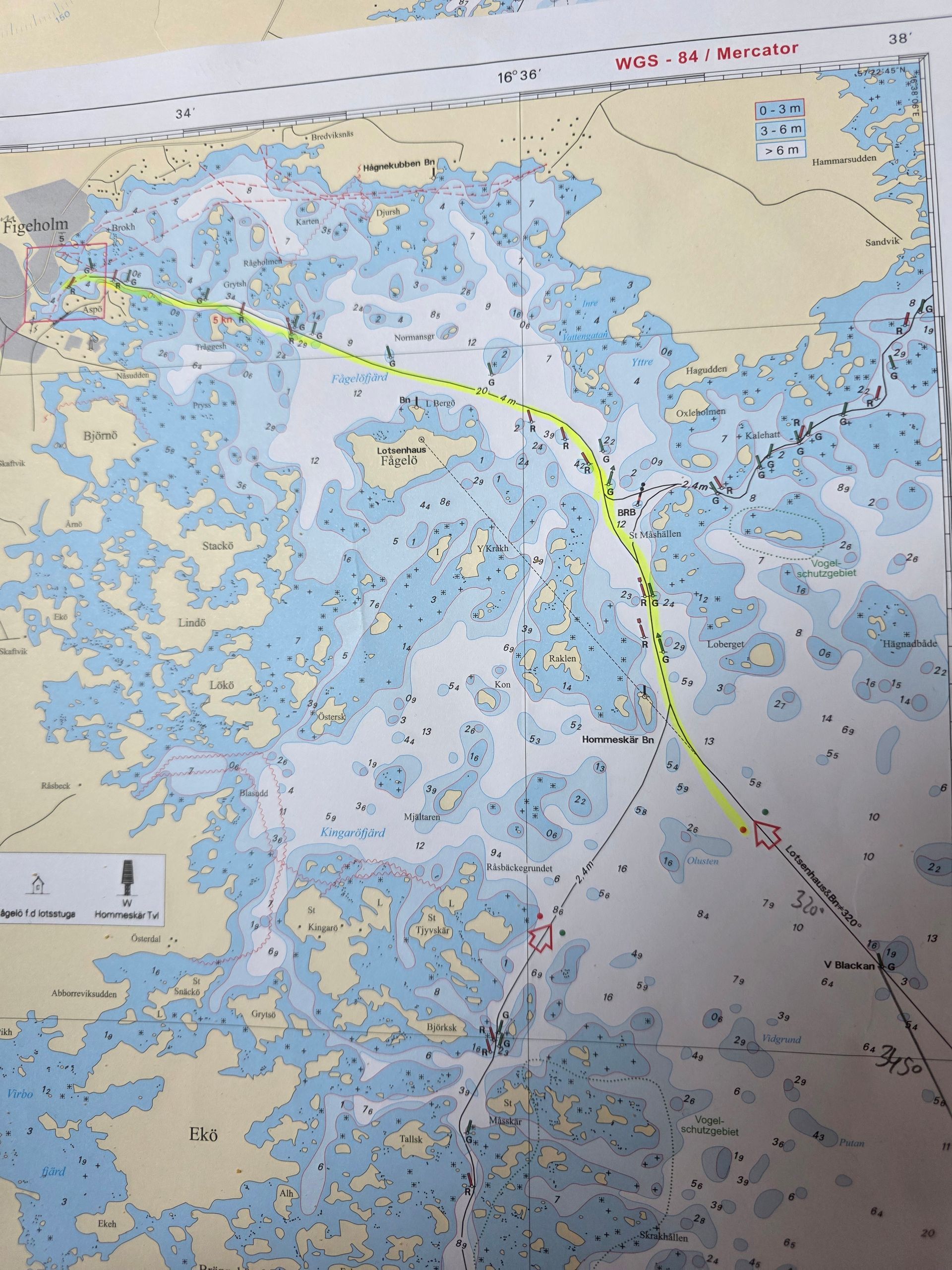 Color nautical chart with a highlighted route line through shallow waters and islands