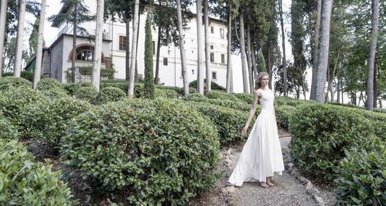 iDress silk modern brides gown immersed in the garden of a beautiful Italian villa