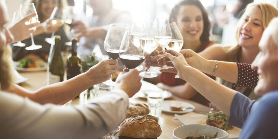 a group of people cheering with wine