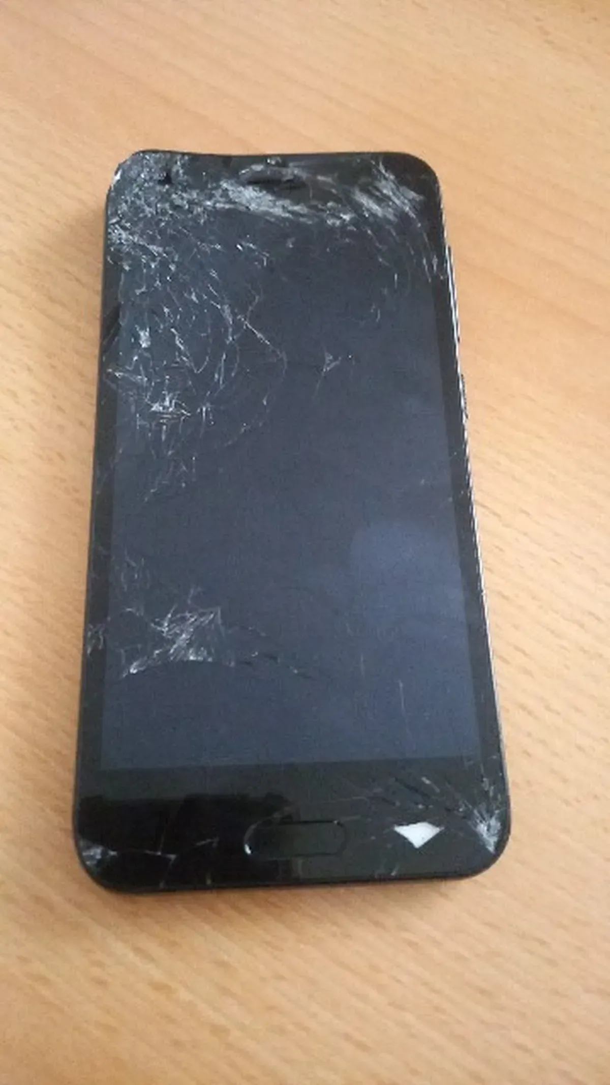 HTC One Smartphone liegt Defekt auf einem Tisch