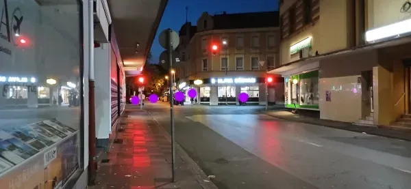 Beleuchtete Geschäftsstraße in Duisburg-Hamborn bei Nacht.